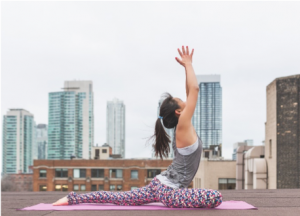 woman dofng yoga on a building rood