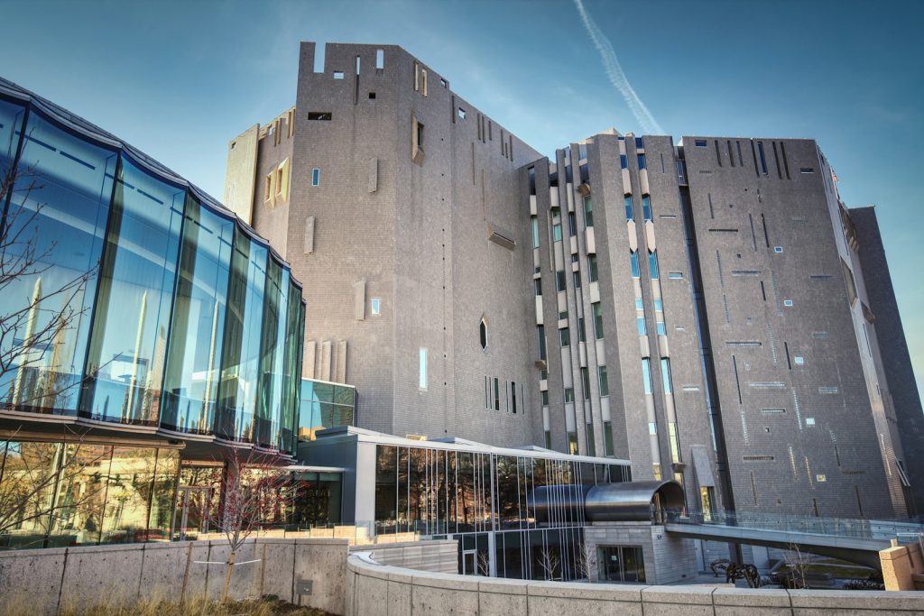 a large building with a curved walkway in front of it