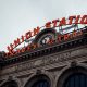 Illuminated sign of Union Station against the architectural detail of the historical building's facade in Denver